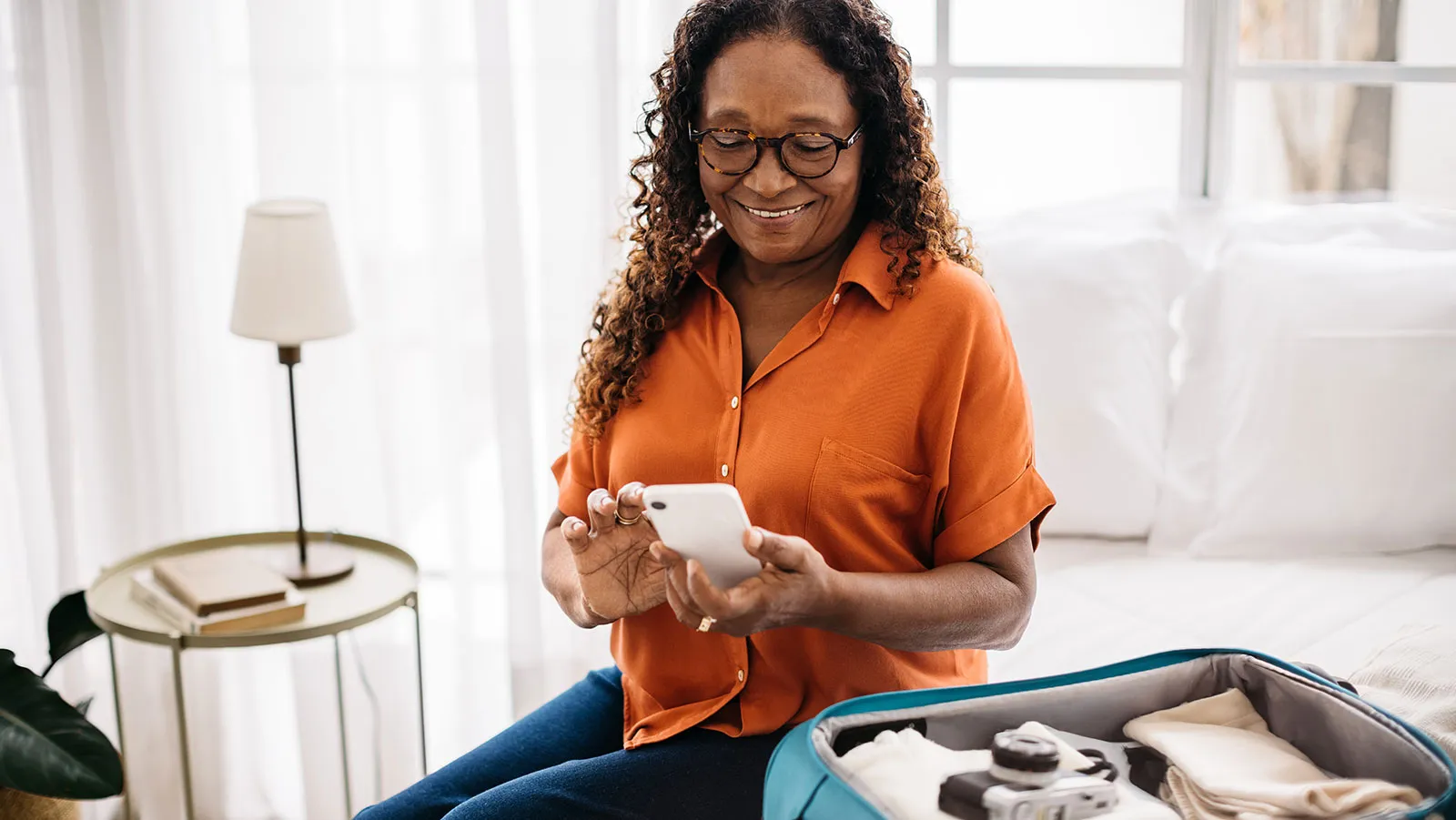 Woman smiling while looking at her phone